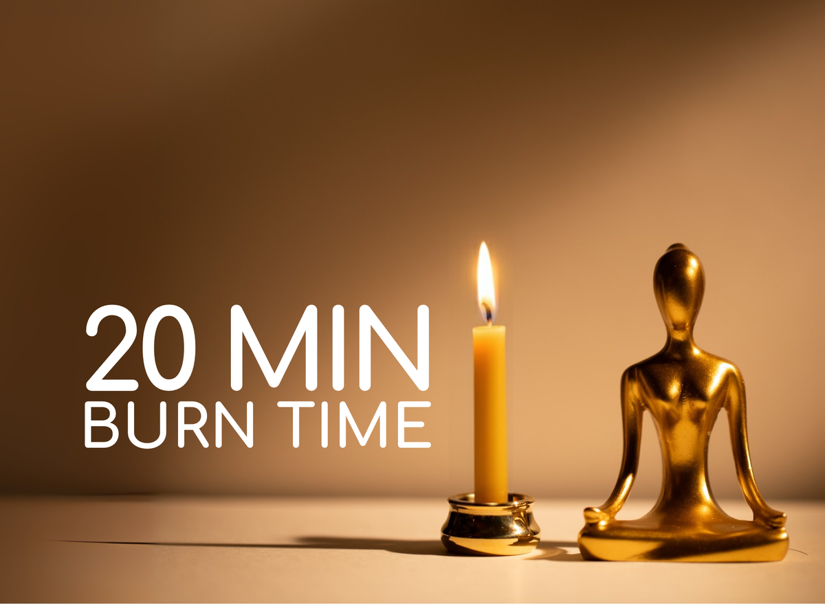 20 min burn time shown beside a lit beeswax candle in the brass meditating figure holder