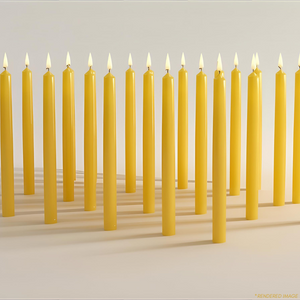 Rows of unlit yellow beeswax meditation candles standing upright